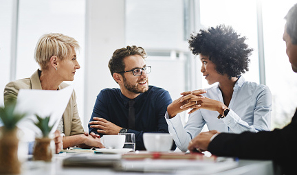 diverse group of people sitting together and having a meeting